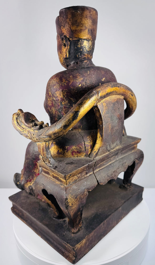 Close-up of Chinese carved wooden official showing dignified facial features, elongated ears and tall square ceremonial cap
