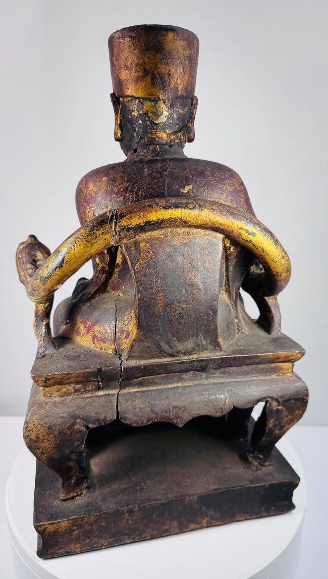 Detail of Qing Dynasty ancestor figure showing hands and fragmentary ritual or court tablet held before the chest