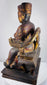 Side view of antique Chinese seated official figure showing carved throne structure, robes and stepped wooden base