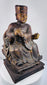 Lower view of Chinese carved wood dignitary showing openwork chair platform, stepped plinth and historic repairs