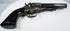 Colt Model 1849 Pocket Revolver highlighting the brass backstrap, rounded walnut grip base, and loading lever beneath the barrel.