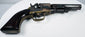 Colt Model 1849 Pocket Revolver highlighting the brass backstrap, rounded walnut grip base, and loading lever beneath the barrel.