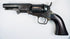 Colt Model 1849 Pocket Revolver with a four-inch octagonal barrel, five-shot cylinder, and curved walnut grip.