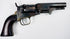 1859 Colt Model 1849 Pocket Revolver displaying mottled cylinder wear, an aged steel frame, and a dark walnut grip.