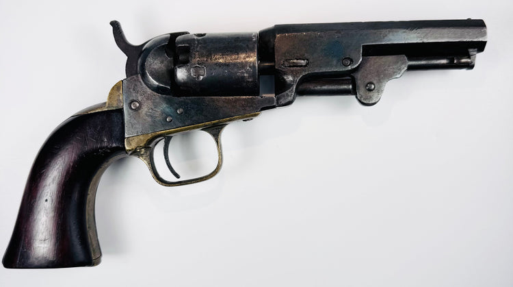 1859 Colt Model 1849 Pocket Revolver displaying mottled cylinder wear, an aged steel frame, and a dark walnut grip.