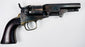 1859 Colt Model 1849 Pocket Revolver displaying mottled cylinder wear, an aged steel frame, and a dark walnut grip.