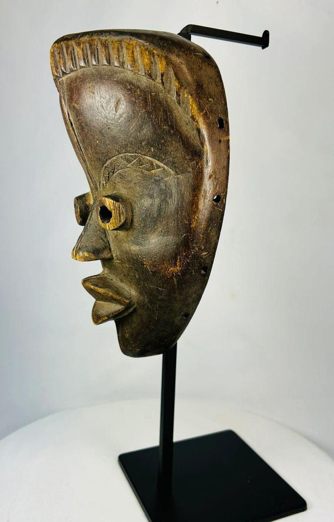 Traditional Baule wooden mask with edge perforations for raffia, circa 1920–1940