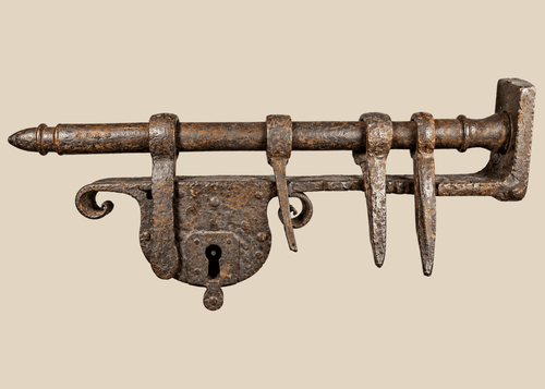 Large 18th-century European wrought-iron sliding hasp gate lock on a wooden display stand