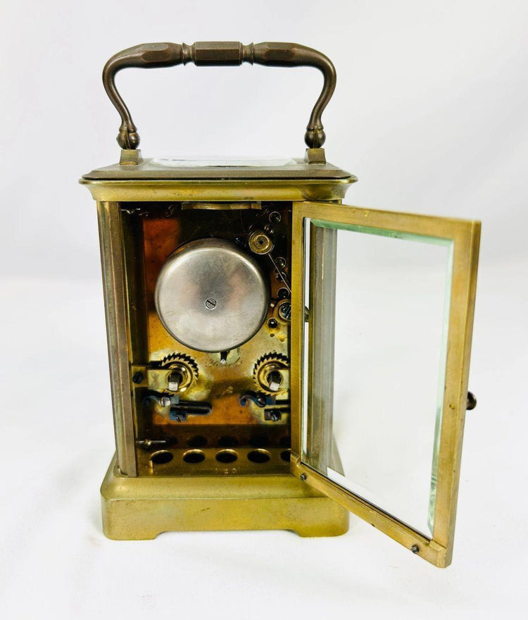 Rear view of antique French brass carriage clock showing maker’s mark and movement access panel.