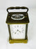 Late 19th-century French brass carriage clock featuring enamel dial and Roman numerals.