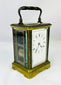 Close-up of Jules Bunelot carriage clock showing detailed brass craftsmanship and glass panels.