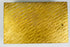 Bottom panel of an antique gold jewelry box showing detailed engraved wavy texture.