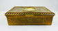 Antique gold decorative box showing engraved floral patterns along the side on a white background.