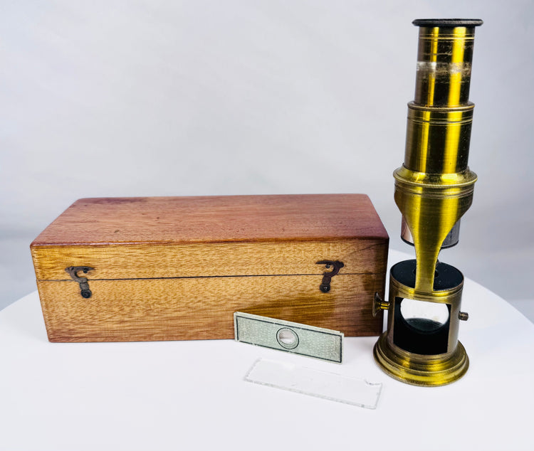 19th century brass drum microscope displayed with original wooden case and antique microscope slides