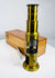 Victorian brass drum microscope featuring mirror illumination and telescoping eyepiece tube