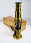 Victorian brass drum microscope featuring mirror illumination and telescoping eyepiece tube