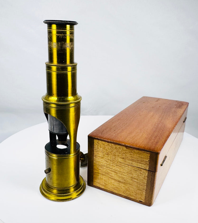 Antique portable brass microscope with fitted hardwood case and historical scientific accessories