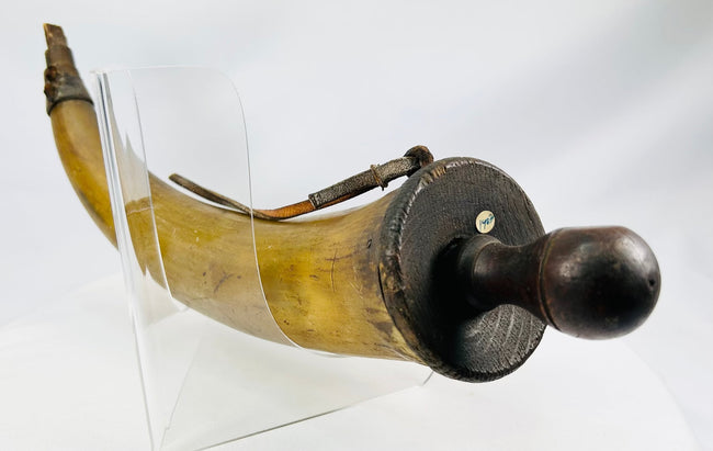 Museum-quality antique powder horn with wooden base and age cracks at spout are