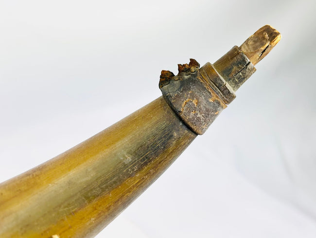Historic black powder horn accessory from flintlock era with original character and patina