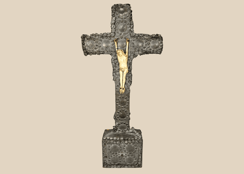 Antique crucifix — direct frontal view highlighting detailed casting and aged patina.