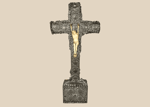 Antique crucifix — direct frontal view highlighting detailed casting and aged patina.