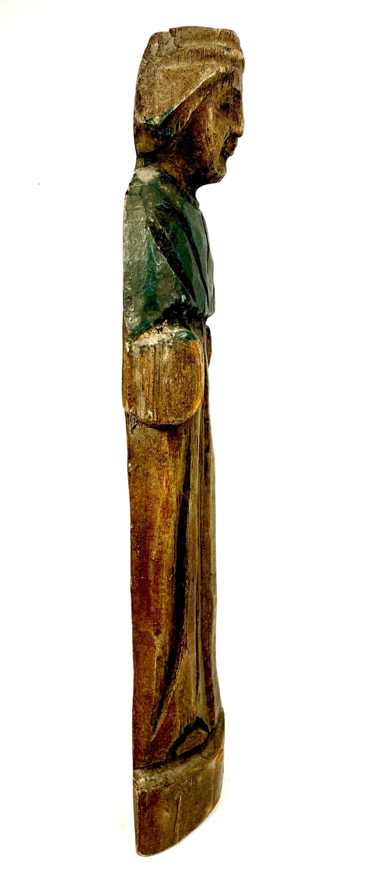 Right profile of hooded antique wooden figurine with deep carved robe grooves