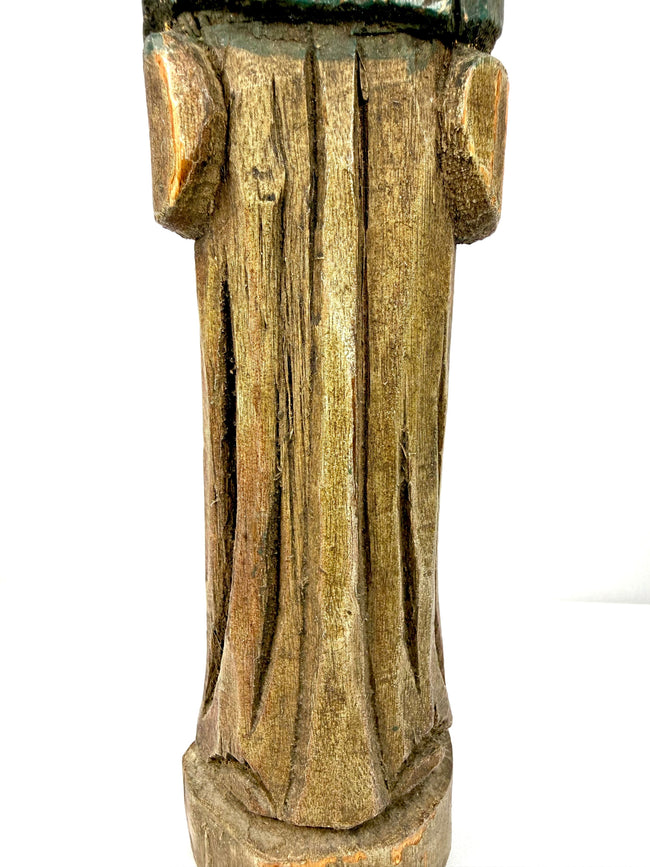 Detail of lower section showing deep vertical grooves and aged wood grain on antique statue