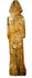 Antique hand-carved wooden figurine back view with green pigment traces and wood grain