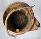 Antique carved wooden vessel with braided decorative patterns and fiber suspension loop