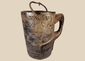Antique Himalayan carved wooden storage vessel with geometric motifs and rope handle