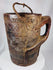 Traditional Himalayan storage vessel displaying geometric carving and rustic tribal craftsmanship