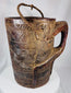 Traditional Himalayan storage vessel displaying geometric carving and rustic tribal craftsmanship