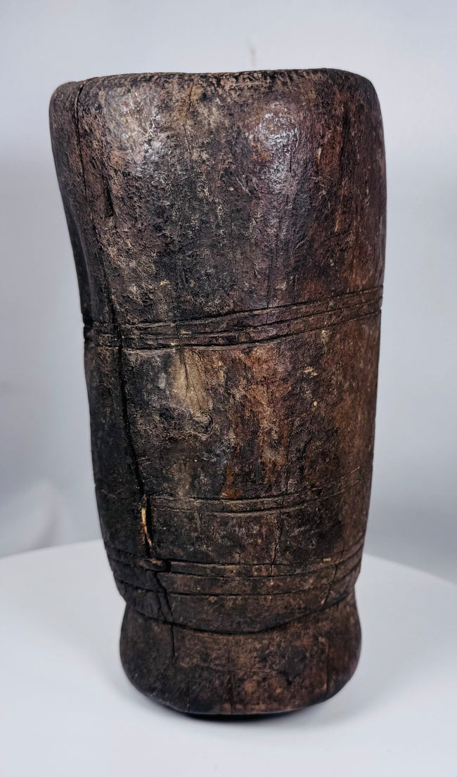 Hand-carved Tibetan hardwood vessel featuring aged cracks, tool marks, and integral side handle