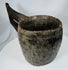 Himalayan carved hardwood vessel displaying primitive craftsmanship and decorative border motifs
