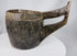 Hand-carved wooden vessel from Nepal or Tibet featuring a deep basin and curved handle