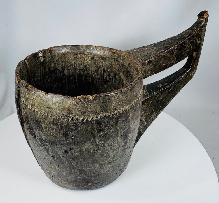 Ethnographic hardwood vessel with carved triangular motifs and integrated handle construction