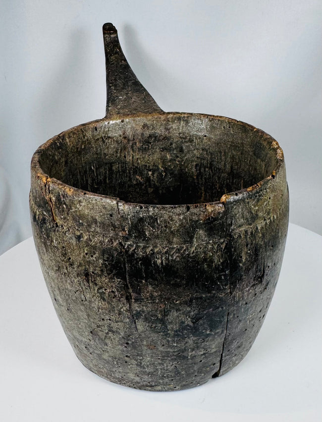 Antique wooden ritual container from the Himalayan region with extensive age-related wear