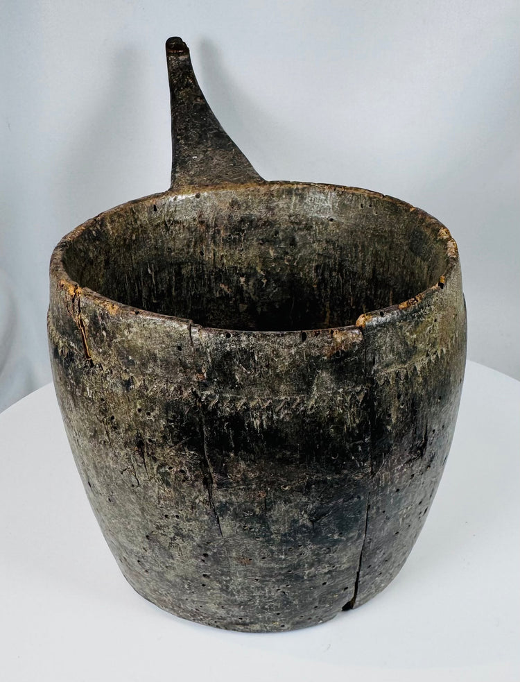 Antique wooden ritual container from the Himalayan region with extensive age-related wear
