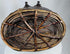 Antique Tibetan storage basket with coiled construction, iron clasps, and aged surface wear