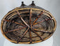 Antique Tibetan storage basket with coiled construction, iron clasps, and aged surface wear