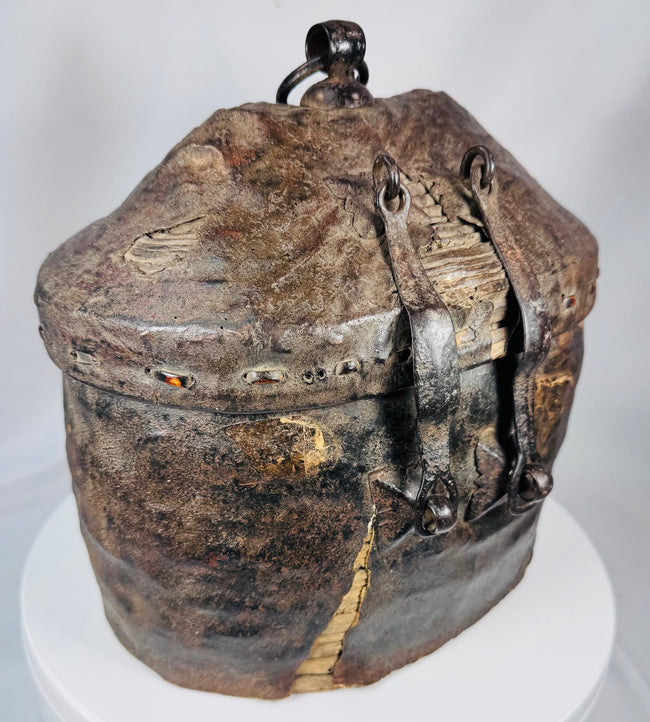 Traditional Tibetan travel basket constructed from woven reed, hide, and iron fittings