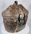 Traditional Tibetan travel basket constructed from woven reed, hide, and iron fittings
