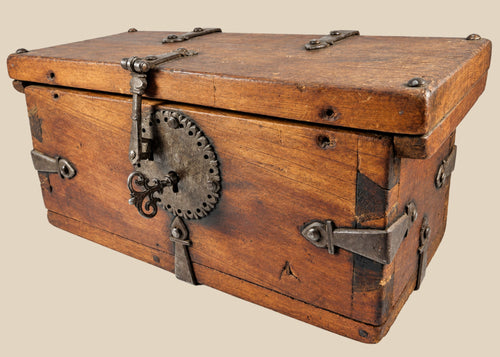 Antique Himalayan lockbox, circa 1780–1820, crafted from elmwood with original hand-forged iron fittings, circular hasp plate, ornate key, and rich aged patina. Historical chest from Northern India, Nepal, or Tibet used for safeguarding valuables.