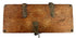 Bottom view of antique wooden strongbox displaying natural wood grain and four rounded iron foot studs