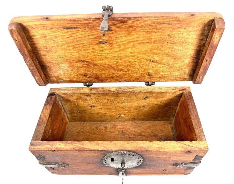 Historic Himalayan lockbox featuring a solid elmwood body, sturdy iron hinges, and decorative metal strapping.