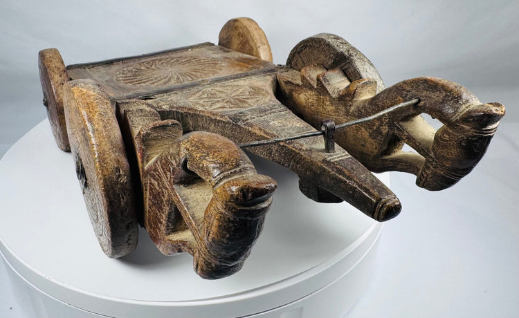 Antique wooden temple-style cart with stylized animal terminals and iron accents