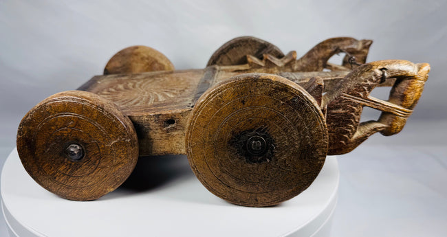 Indian folk art wooden ceremonial cart featuring stylized animal-head terminals