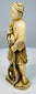 Opposite side view of the Japanese fisherman holding fish against his chest