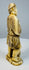 Side view of a Japanese carved fisherman standing barefoot on an oval base