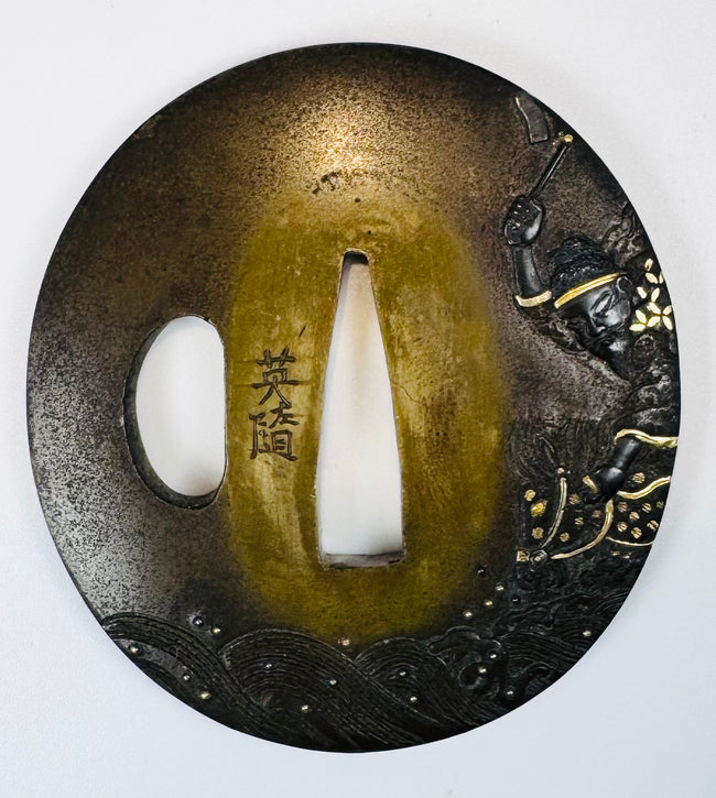 Antique Japanese tsuba signed Eizui with gold and silver inlay and warrior riding a horse through turbulent waves